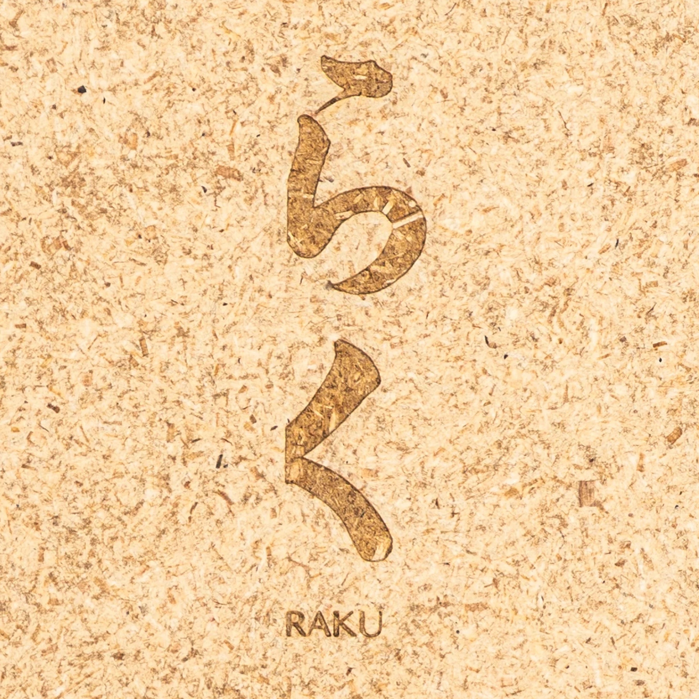 Hardboard material with engraved text and 'RAKU' branding on a white background