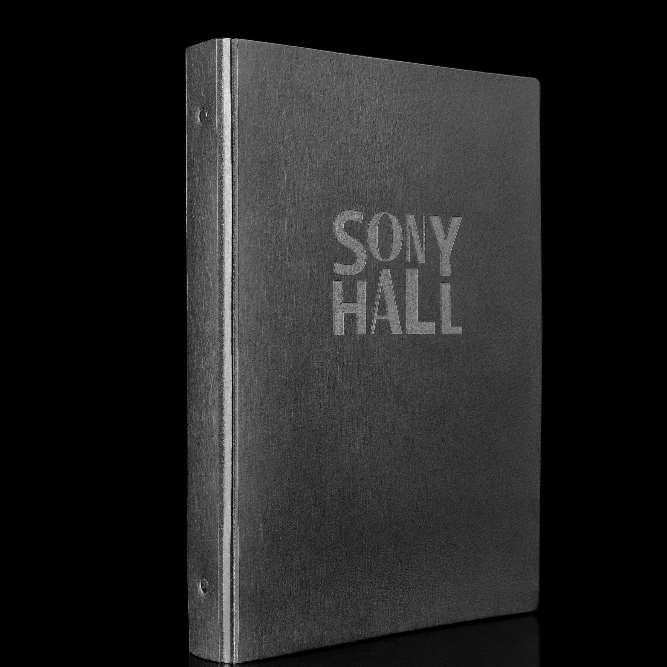 Black leather binder with 'SONY HALL' etched on the cover